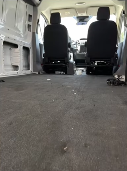 Worn factory floor in a bare Ford Transit cargo area